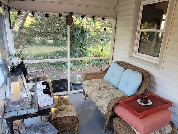 a living room with furniture and a floor to ceiling window