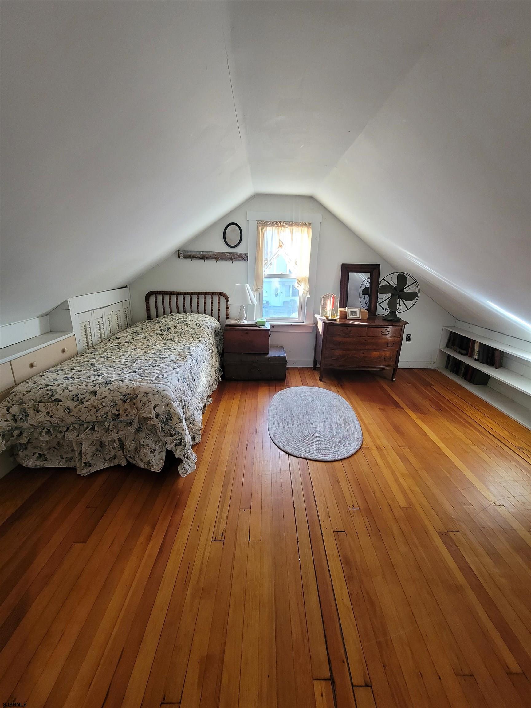 804 2nd Street Somers Point, NJ 08244 - Photo 20 of 29 a bedroom with a bed and wooden floor