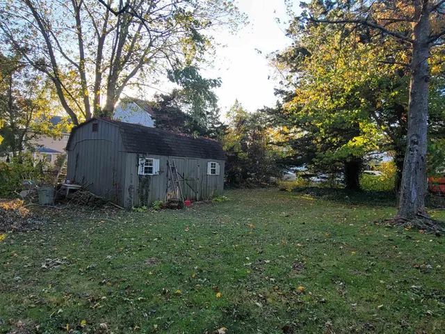 a view of a barn in the middle of a yard