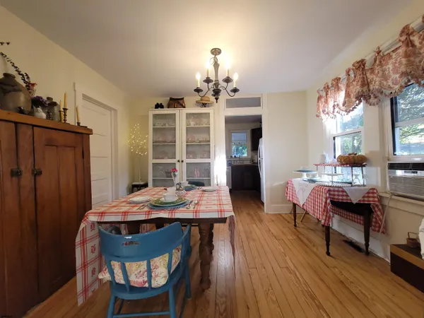 a view of a dining room with furniture and wooden floor