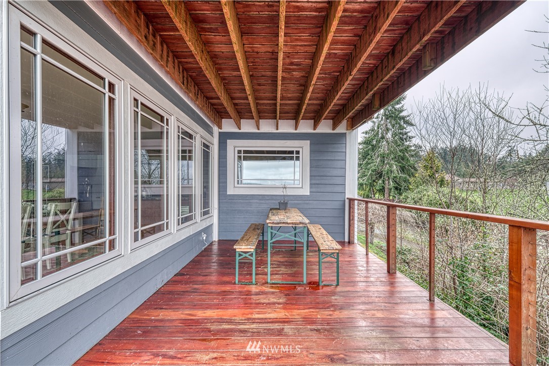 8315 Walnut Road Northeast Olympia, WA 98516 - Photo 16 of 40 a porch with wooden floors in outdoor space