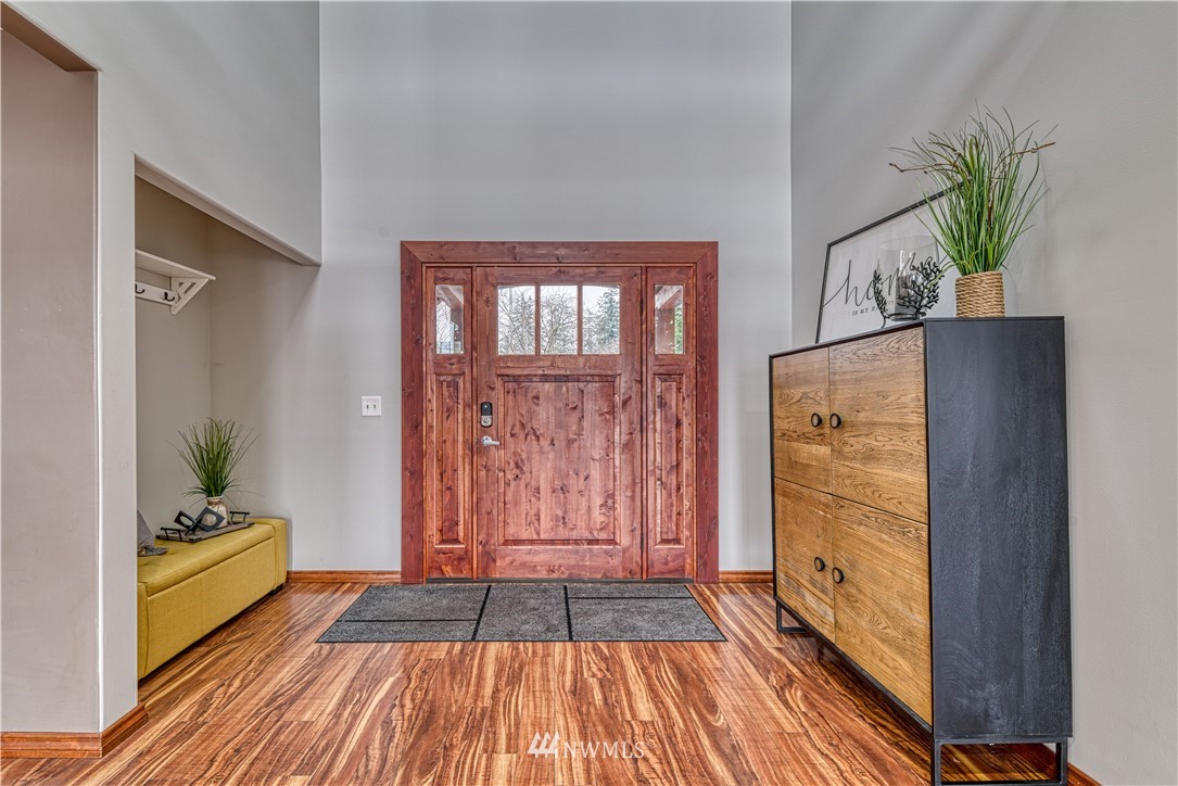 8315 Walnut Road Northeast Olympia, WA 98516 - Photo 8 of 40 a view of a hallway with wooden floor and furniture