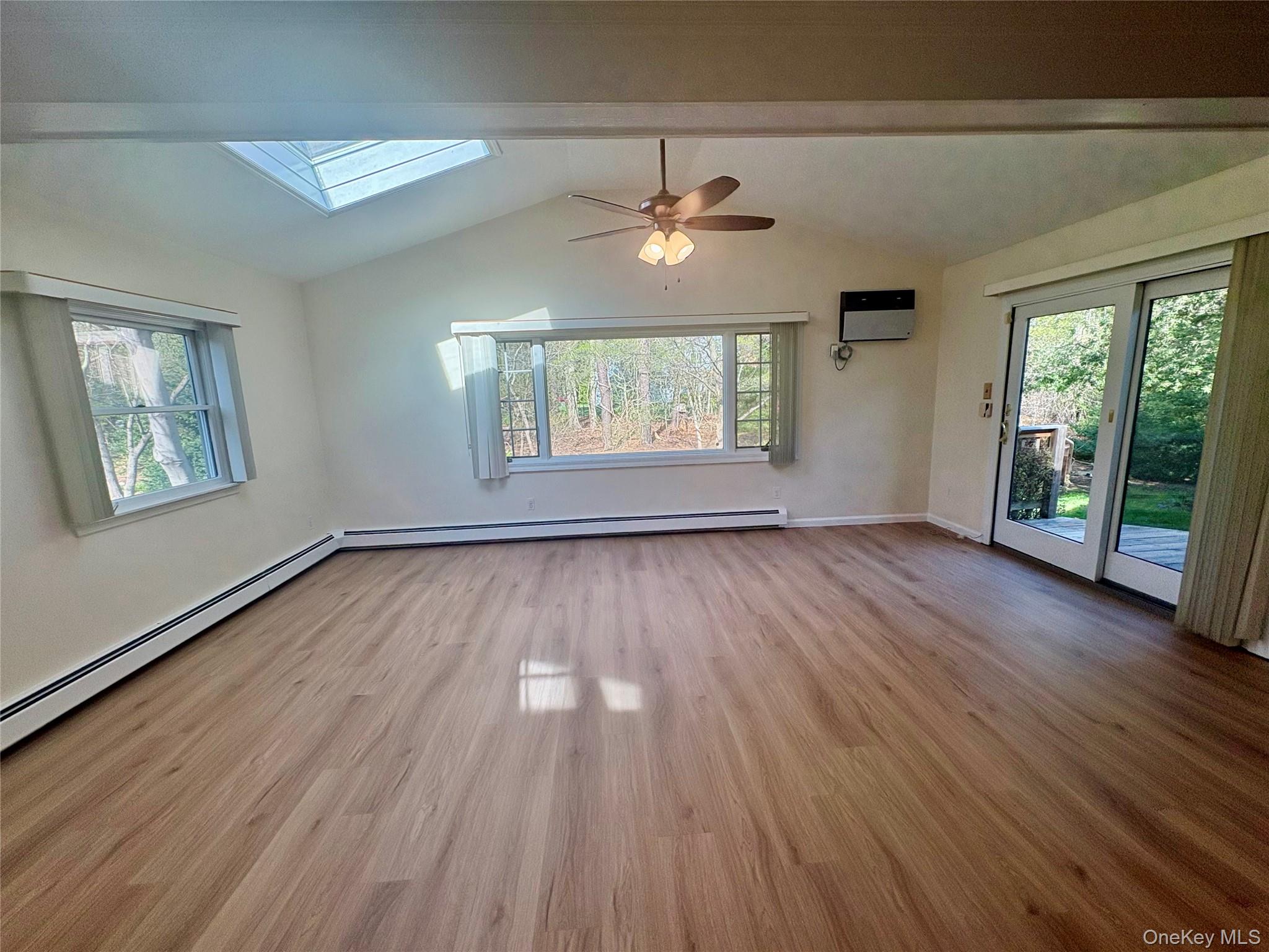 54 Old Brook Road Dix Hills, NY 11746 - Photo 3 of 15 a view of an empty room with wooden floor and a window