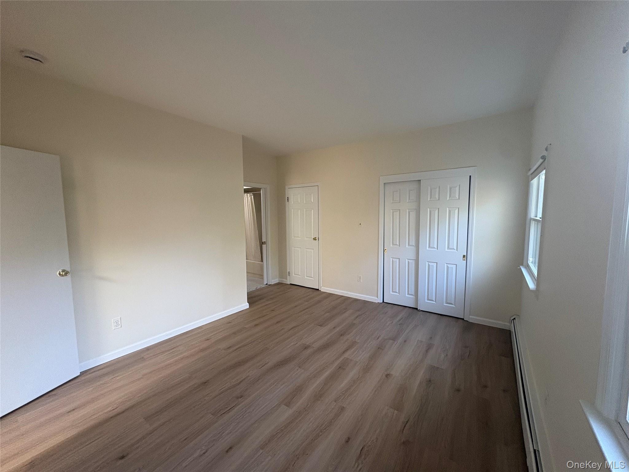 54 Old Brook Road Dix Hills, NY 11746 - Photo 6 of 15 a view of an empty room with wooden floor and closet