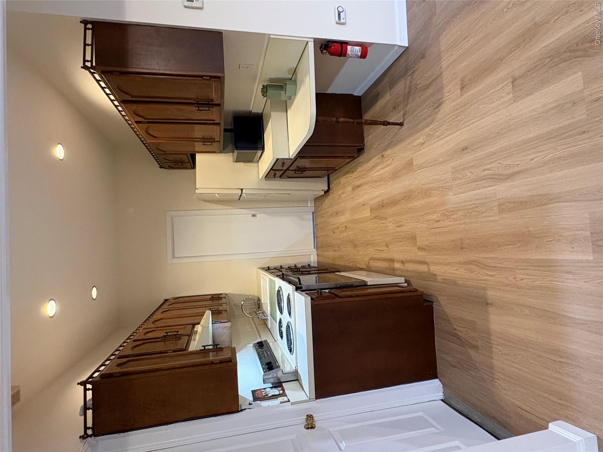 54 Old Brook Road Dix Hills, NY 11746 - Photo 7 of 15 a kitchen with kitchen island stainless steel appliances a sink stove and refrigerator