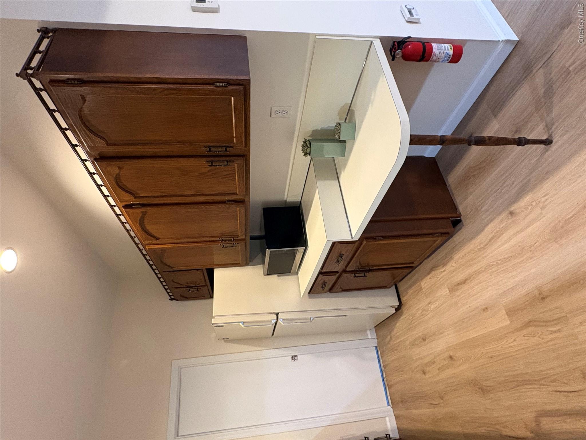 54 Old Brook Road Dix Hills, NY 11746 - Photo 9 of 15 a kitchen with a sink a refrigerator and cabinets