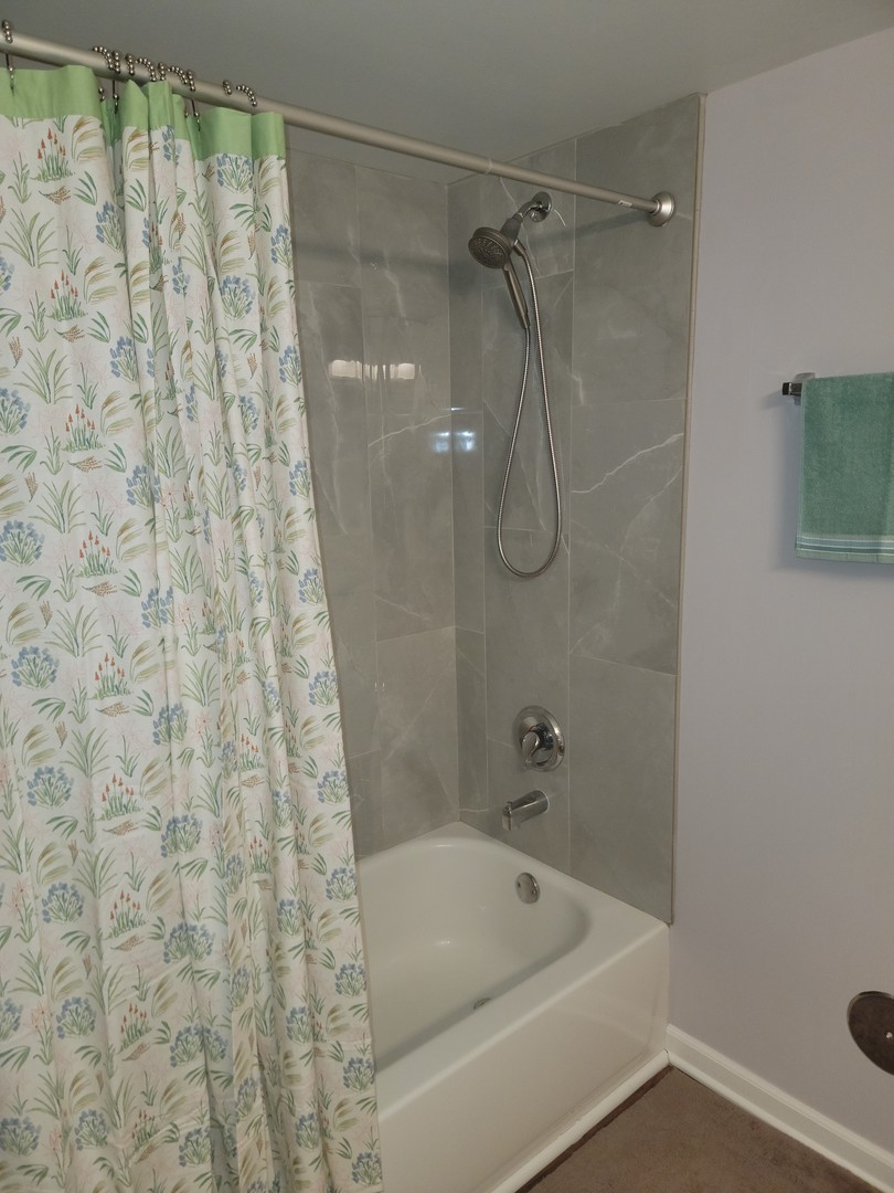237 North Mill Road, Unit 3 Addison, IL 60101 - Photo 20 of 23 a bathroom with a shower and a bath tub