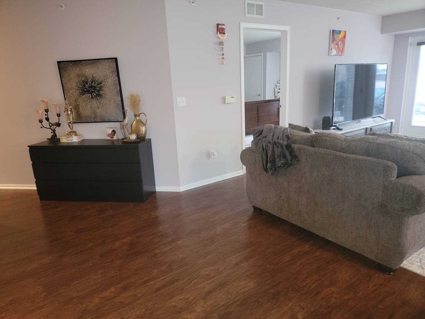 237 North Mill Road, Unit 3 Addison, IL 60101 - Photo 7 of 23 a living room with furniture and a flat screen tv