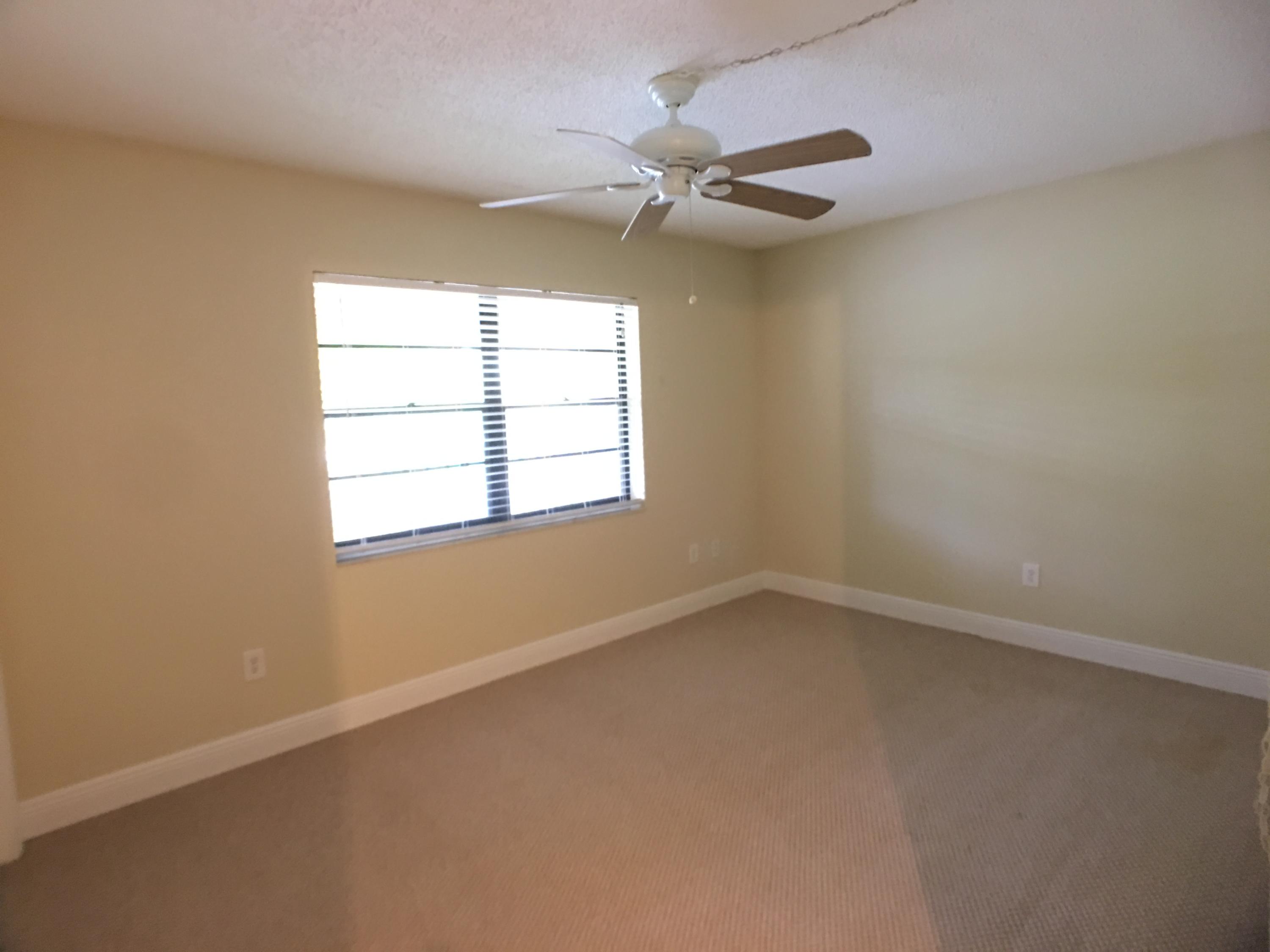 23398 Southwest 57th Avenue, Unit 309 Boca Raton, FL 33428 - Photo 15 of 29 an empty room with a window