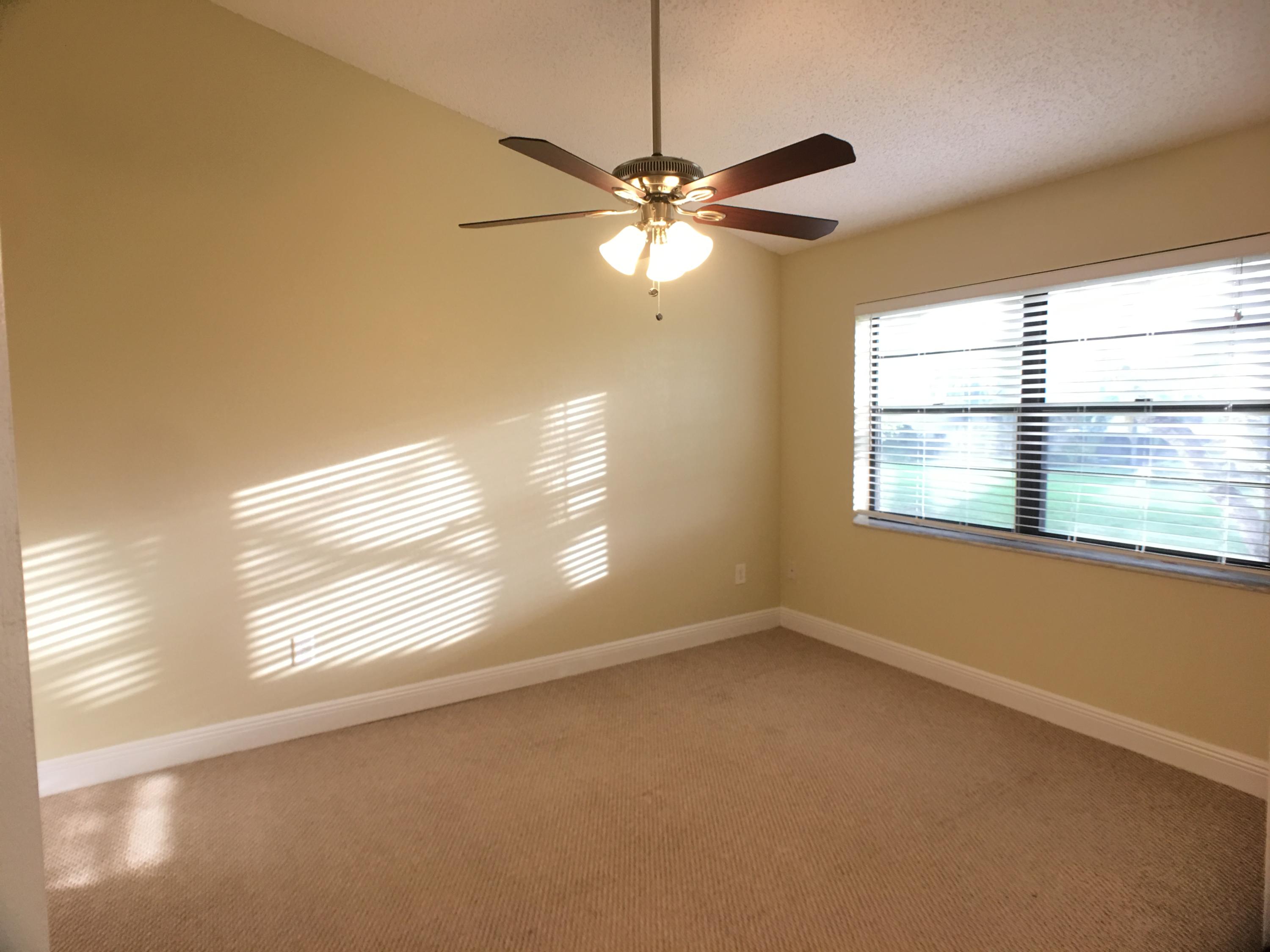 23398 Southwest 57th Avenue, Unit 309 Boca Raton, FL 33428 - Photo 23 of 29 a view of empty room with window and chandelier fan