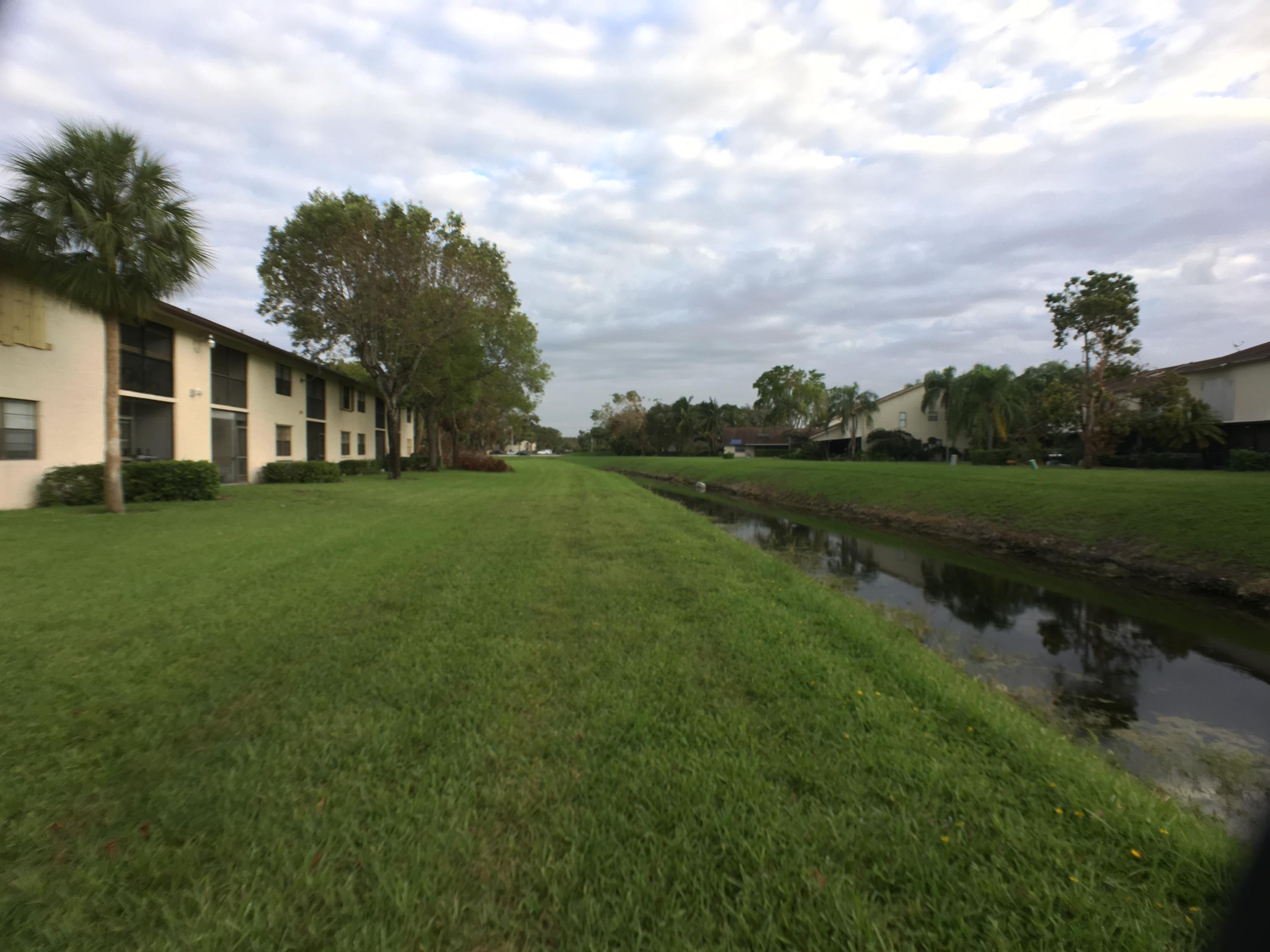 23398 Southwest 57th Avenue, Unit 309 Boca Raton, FL 33428 - Photo 26 of 29 a view of a yard with a house in the background