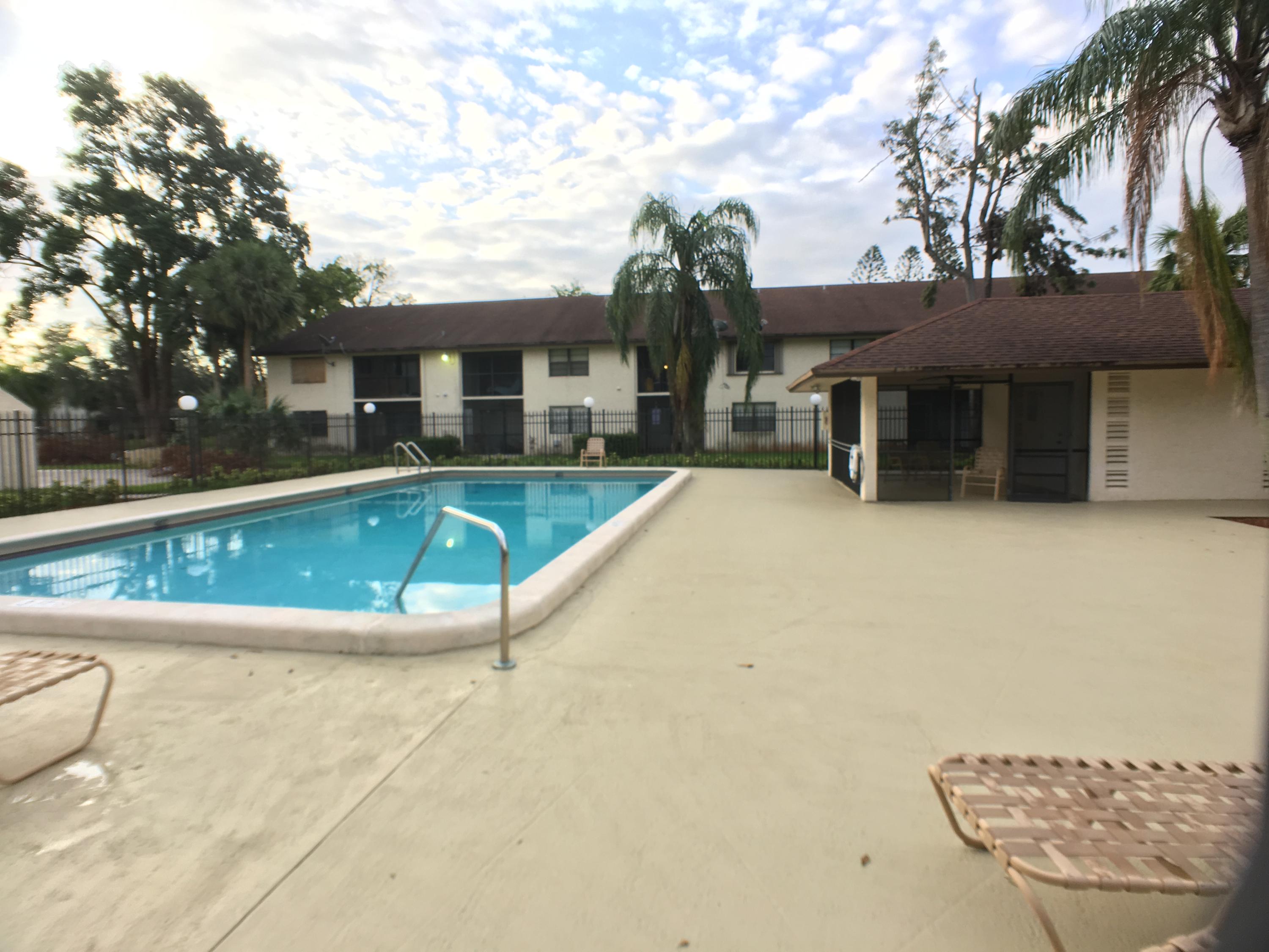 23398 Southwest 57th Avenue, Unit 309 Boca Raton, FL 33428 - Photo 29 of 29 a view of a house with pool and sitting area