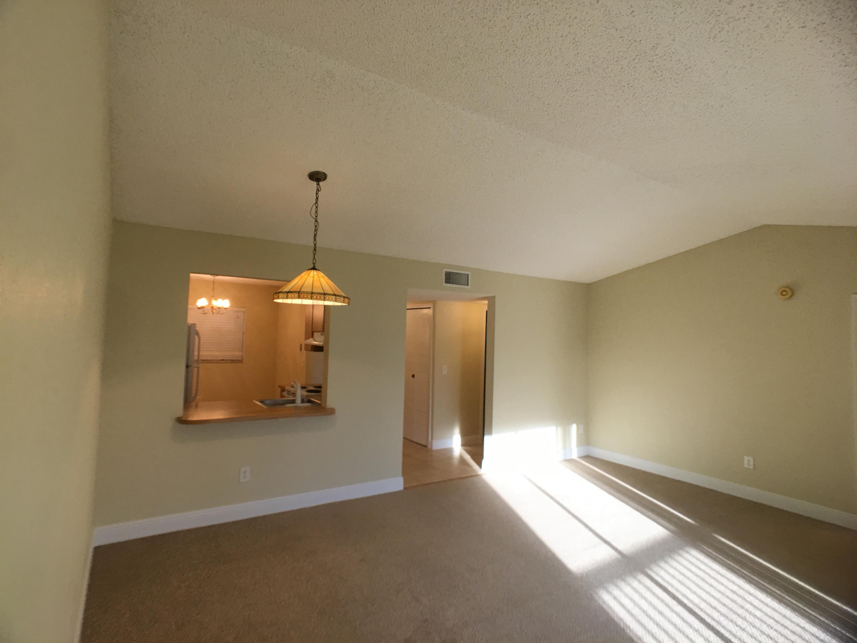 23398 Southwest 57th Avenue, Unit 309 Boca Raton, FL 33428 - Photo 7 of 29 a view of a room with a chandelier
