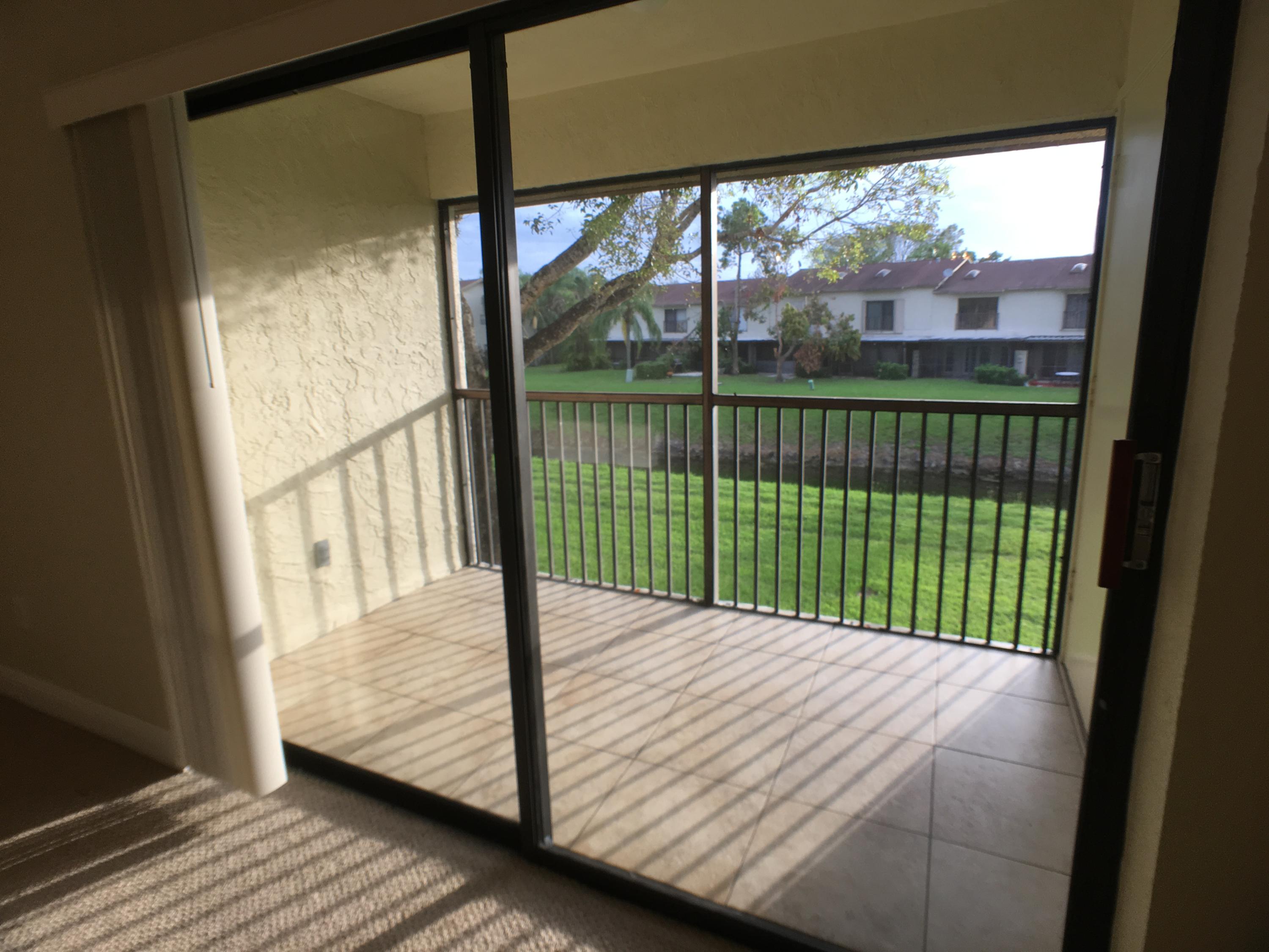 23398 Southwest 57th Avenue, Unit 309 Boca Raton, FL 33428 - Photo 9 of 29 a bed sitting in front of a window