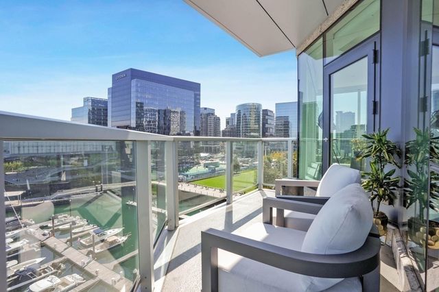 a view of a balcony with lake view and a potted plant