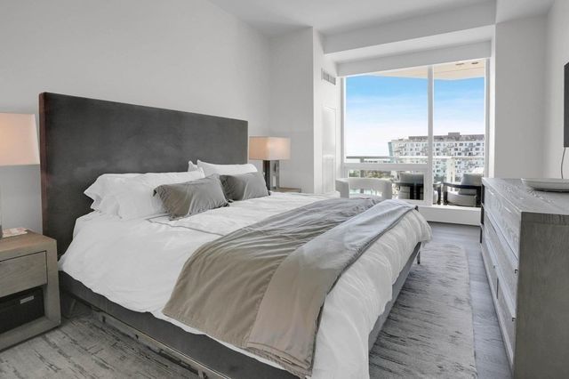 a spacious bedroom with a bed and large window