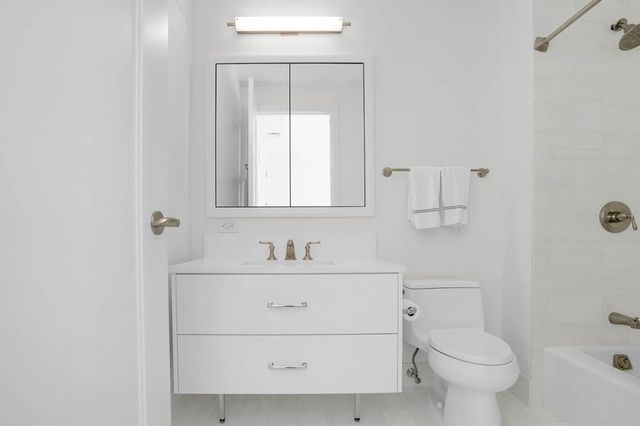 a bathroom with a shower and a bath tub