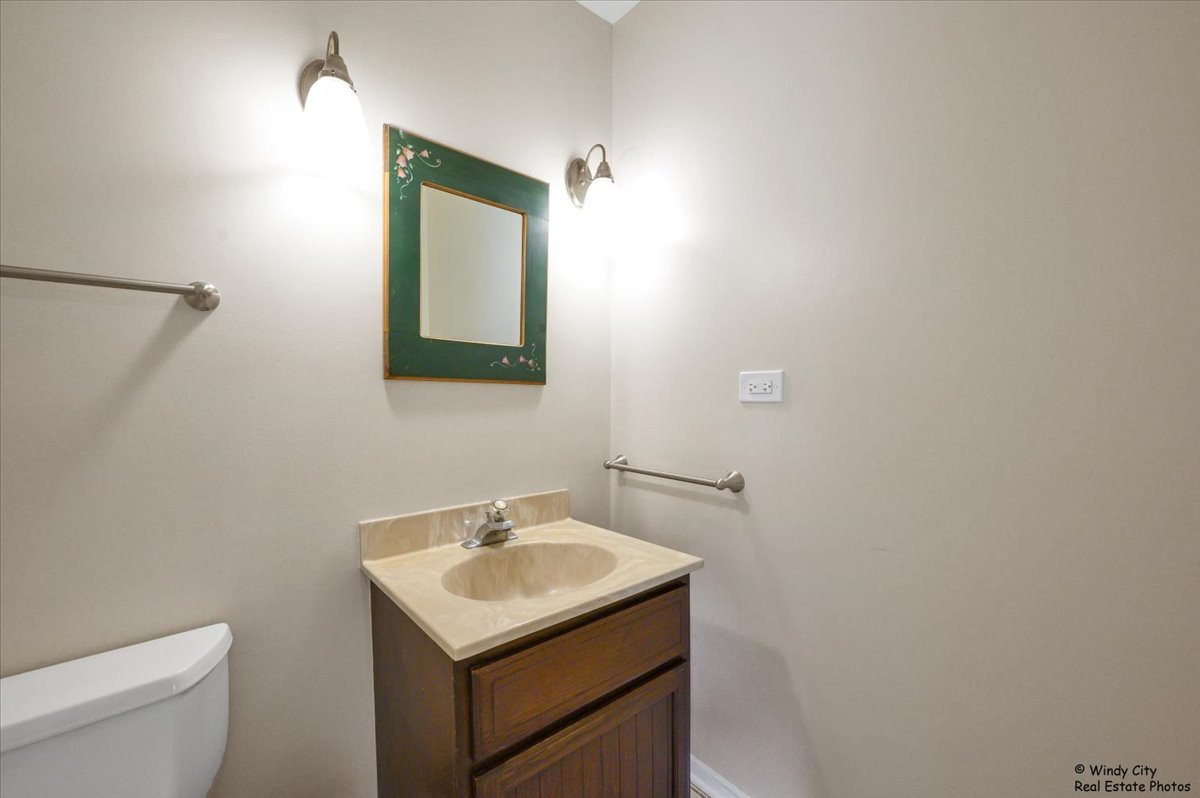 420 North Wille Street Mount Prospect, IL 60056 - Photo 12 of 28 a bathroom with a sink toilet and mirror
