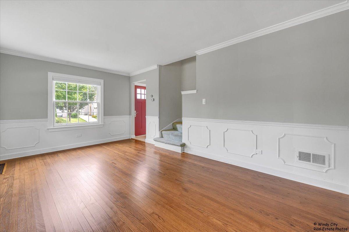 420 North Wille Street Mount Prospect, IL 60056 - Photo 3 of 28 a view of an empty room with wooden floor and a window