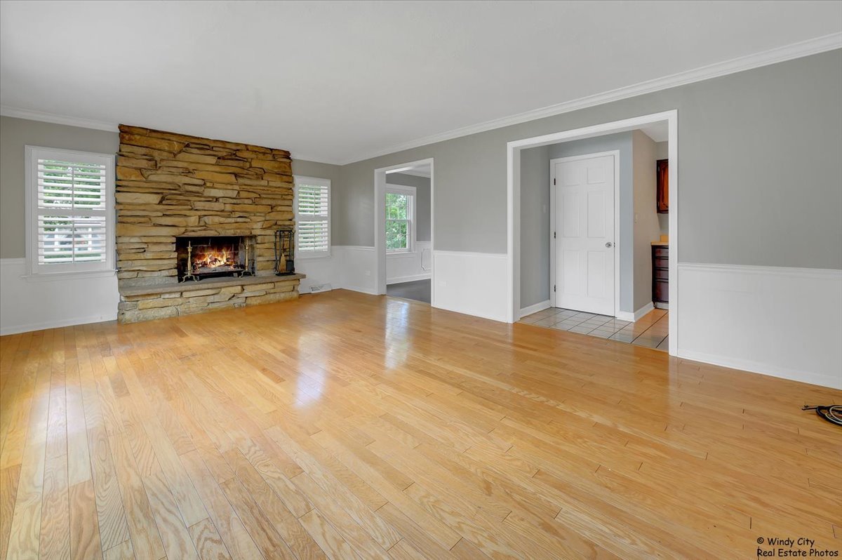 420 North Wille Street Mount Prospect, IL 60056 - Photo 5 of 28 a view of an empty room with wooden floor fireplace and a window