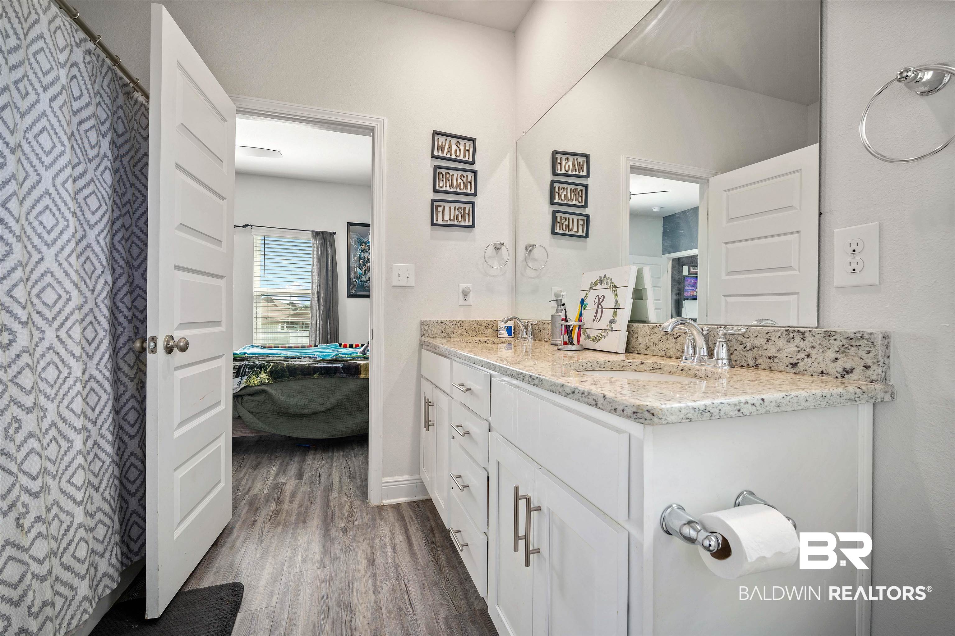 24341 Alydar Loop Daphne, AL 36526 - Photo 27 of 45 Bathroom with connected bathroom, wood finished floors, vanity, and baseboards