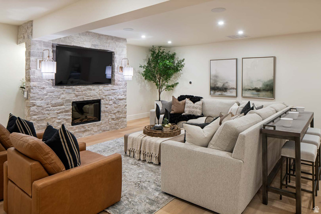 423 Eldorado Drive Mapleton, UT 84664 - Photo 29 of 40 Living area featuring light wood-type flooring, a stone fireplace, and recessed lighting