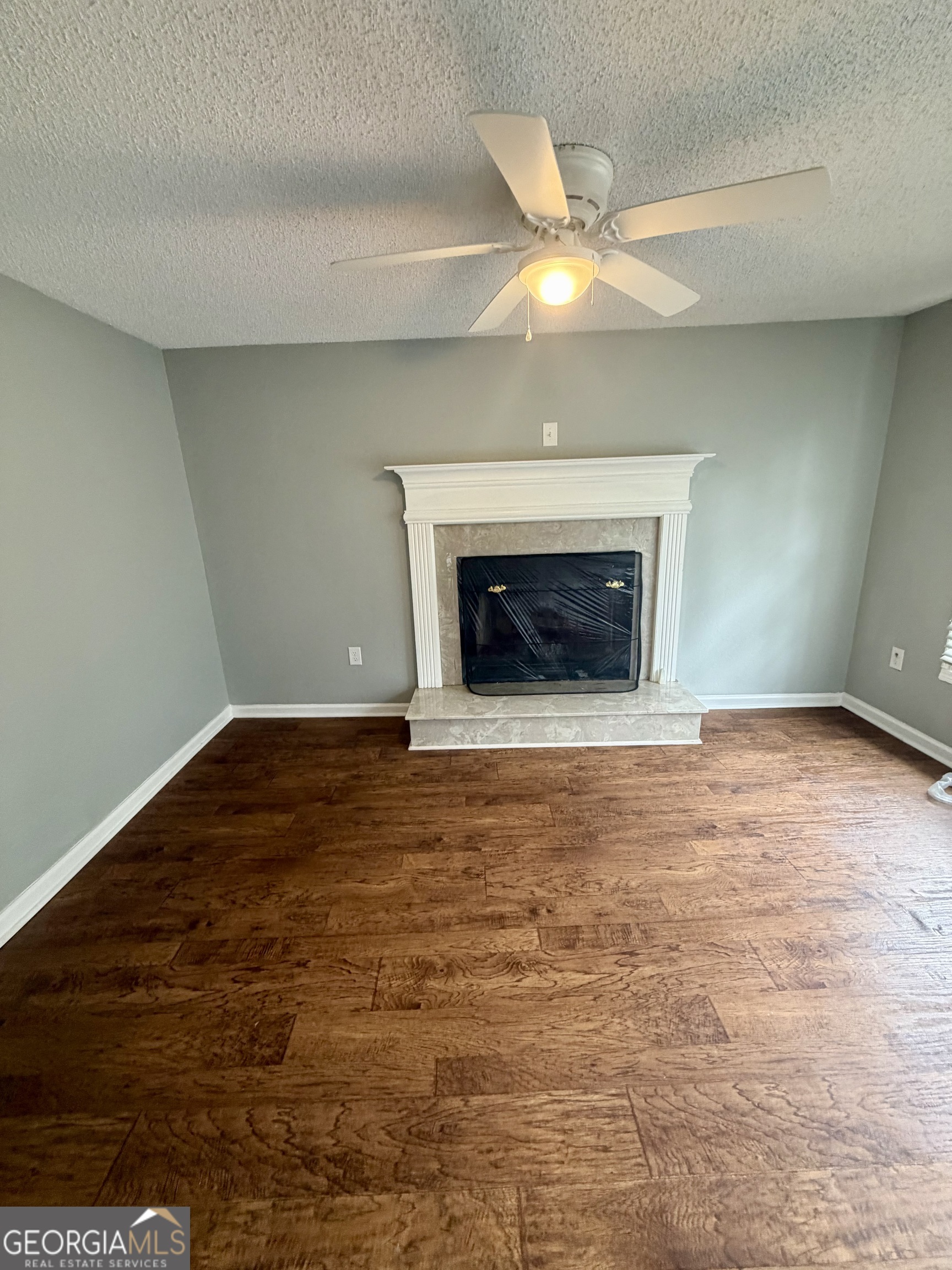 666 Woolfolk Street Macon, GA 31217 - Photo 12 of 60 wooden floor fireplace and natural light in room