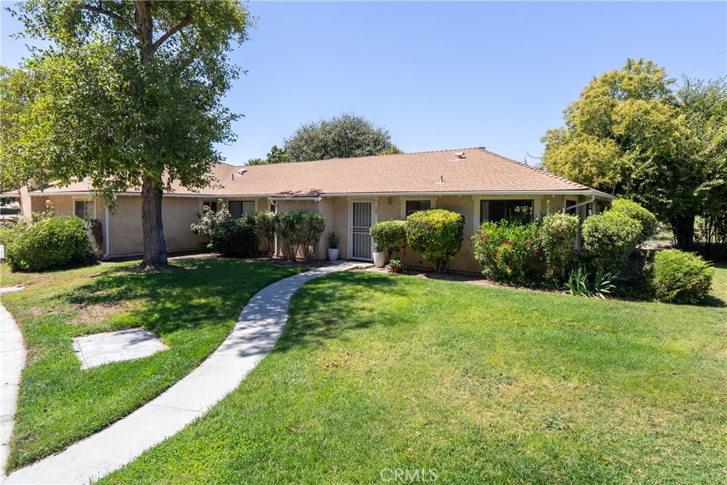 10 Flag Way, Unit C Paso Robles, CA 93446 - Photo 2 of 32 a view of a garden with a table and chairs under an umbrella