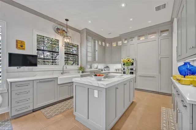 a kitchen with a sink and a stove top oven