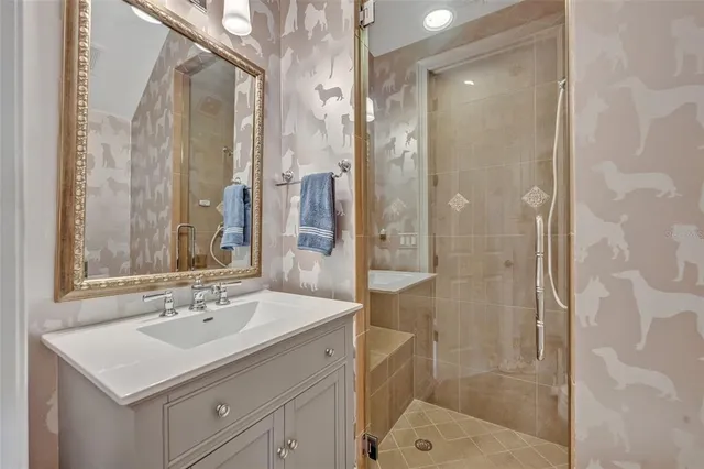 a bathroom with a sink a shower and a mirror