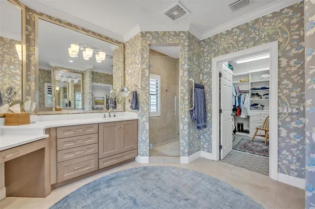 a spacious bathroom with a shower a sink and a mirror