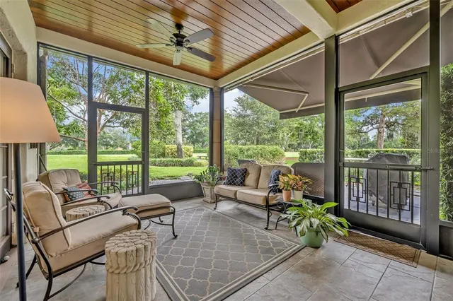 a living room with furniture and floor to ceiling windows