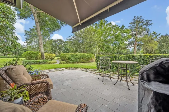 a view of backyard with seating space and trees