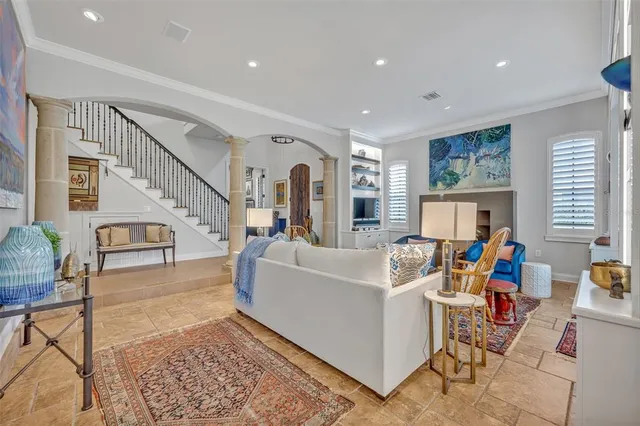 a living room with furniture and a dining table with rug floor