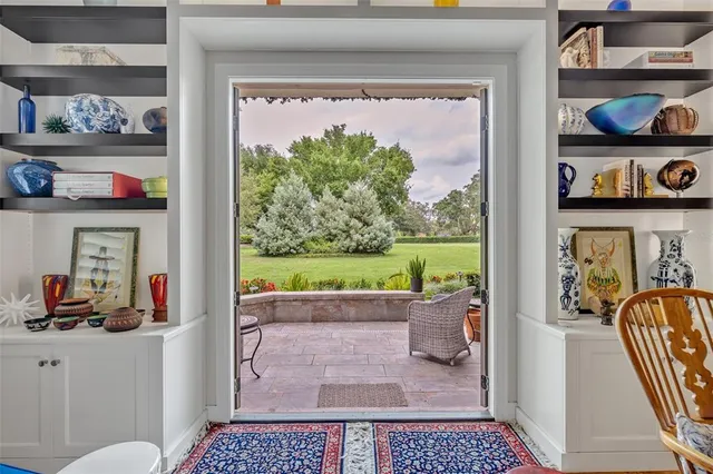 a living room with lots of furniture and a floor to ceiling window
