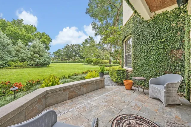 a backyard of a house with outdoor seating