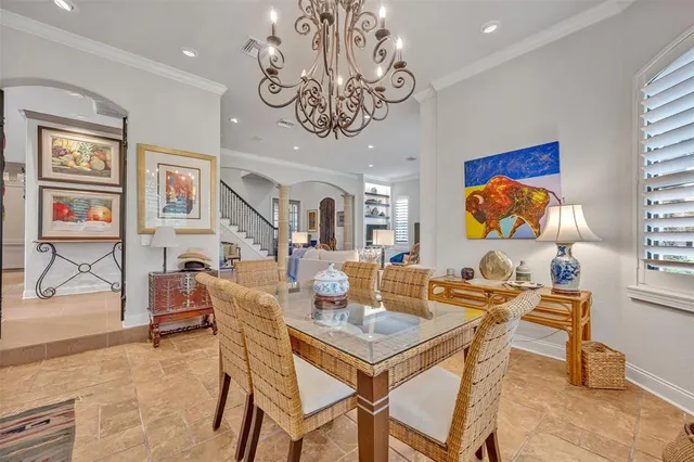 a view of a dining room with furniture a chandelier and wooden floor