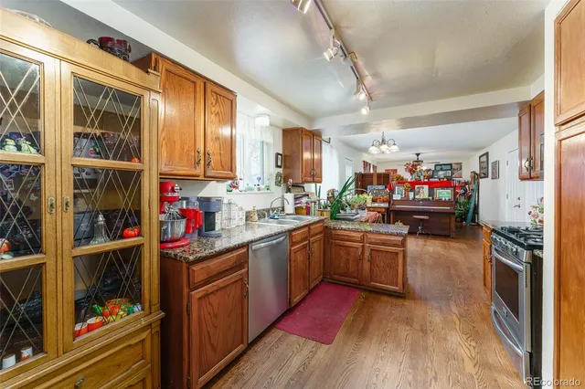a kitchen with lots of counter top space and wooden floor
