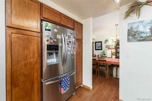 a kitchen with stainless steel appliances granite countertop a refrigerator and a stove top oven