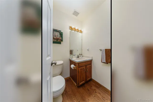 a bathroom with a toilet a sink and mirror