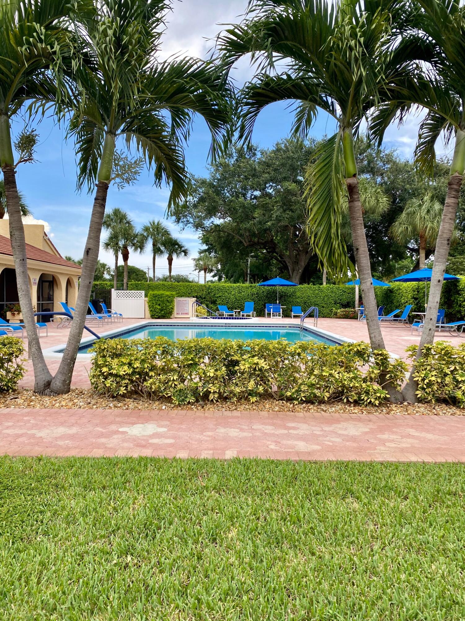 9170 Southwest 14th Street, Unit 4405 Boca Raton, FL 33428 - Photo 43 of 48 a front view of a house with garden and sitting area