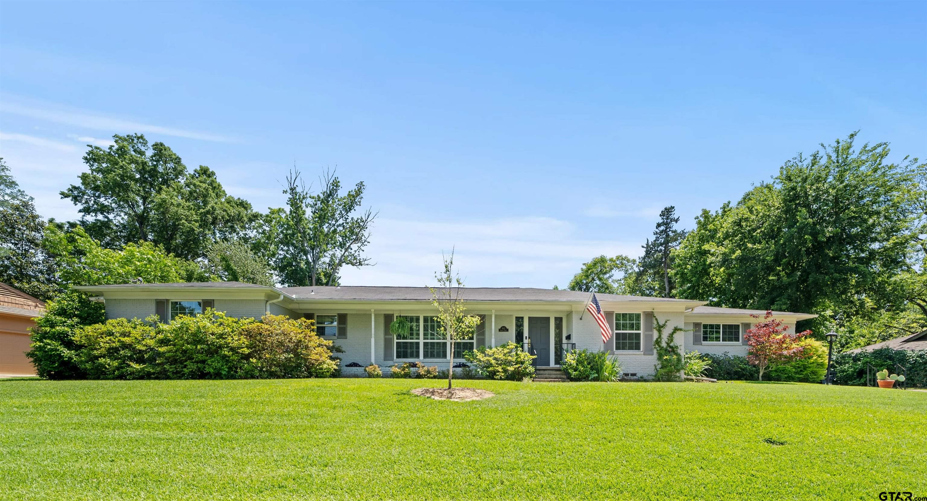 a front view of a house with a garden