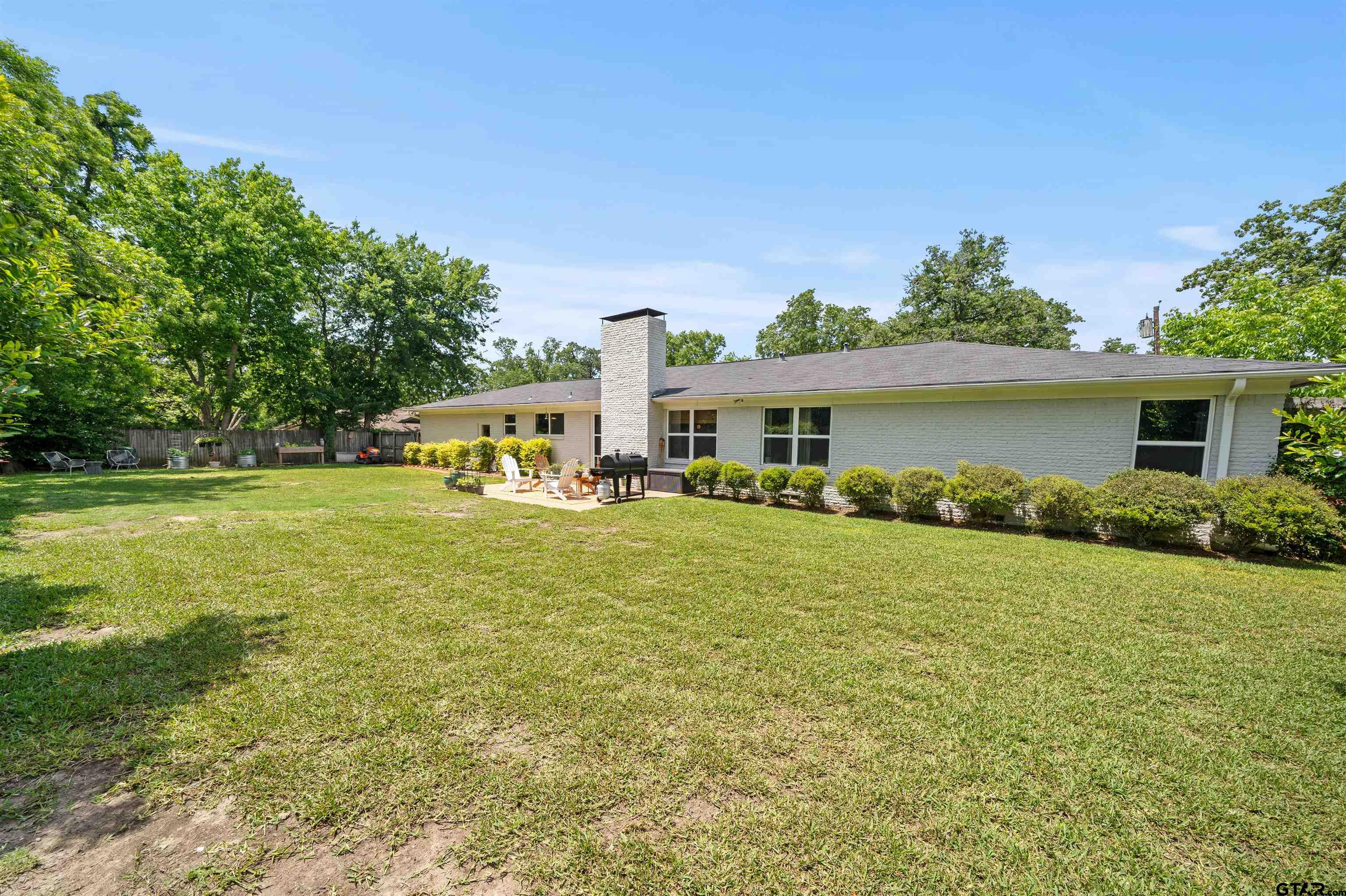 917 Rhodes Drive Tyler, TX 75701 - Photo 25 of 27 a front view of a house with garden