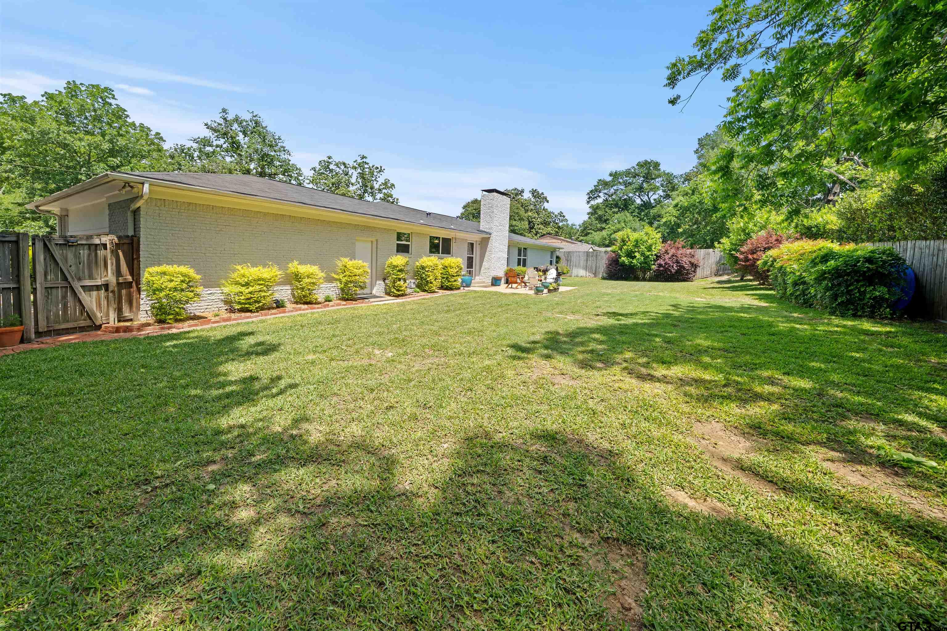 917 Rhodes Drive Tyler, TX 75701 - Photo 26 of 27 a view of a back yard of the house