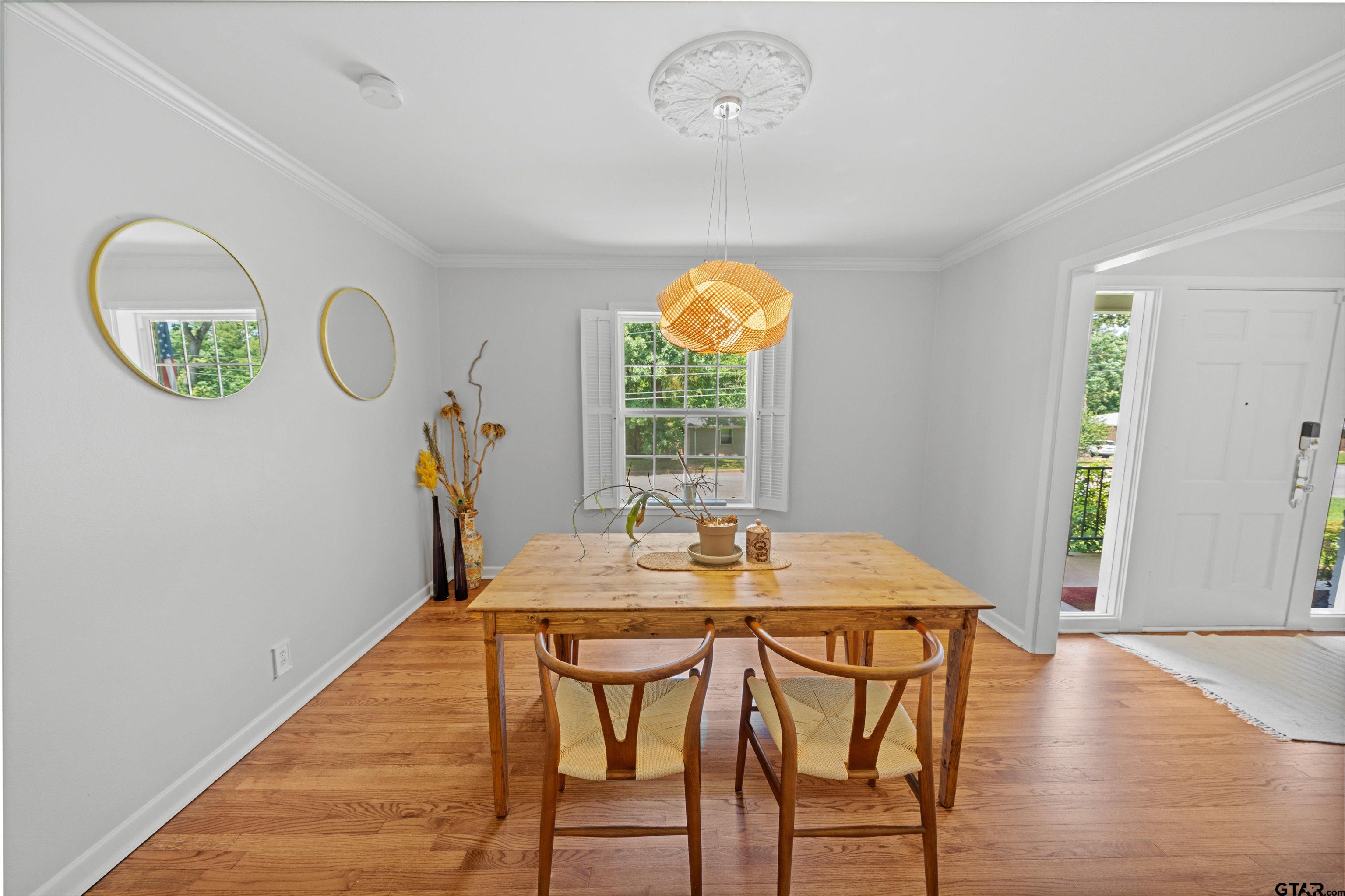 917 Rhodes Drive Tyler, TX 75701 - Photo 7 of 27 a view of a dining room with furniture window and wooden floor