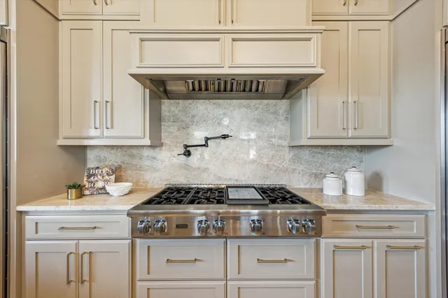 a spacious bathroom with a granite countertop sink mirror and a bathtub