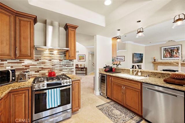 a kitchen with stainless steel appliances a stove sink and cabinets