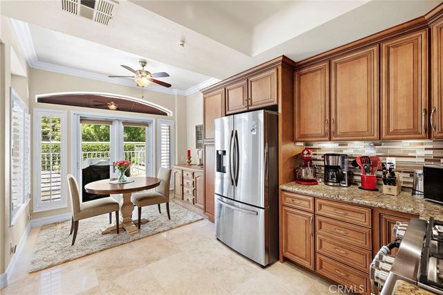 a kitchen with refrigerator cabinets and chairs
