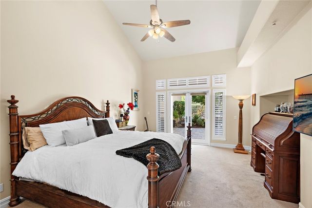 a bedroom with a bed and a flat tv screen