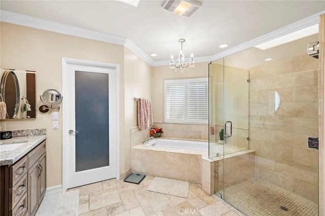 a spacious bathroom with a tub shower sink and mirror